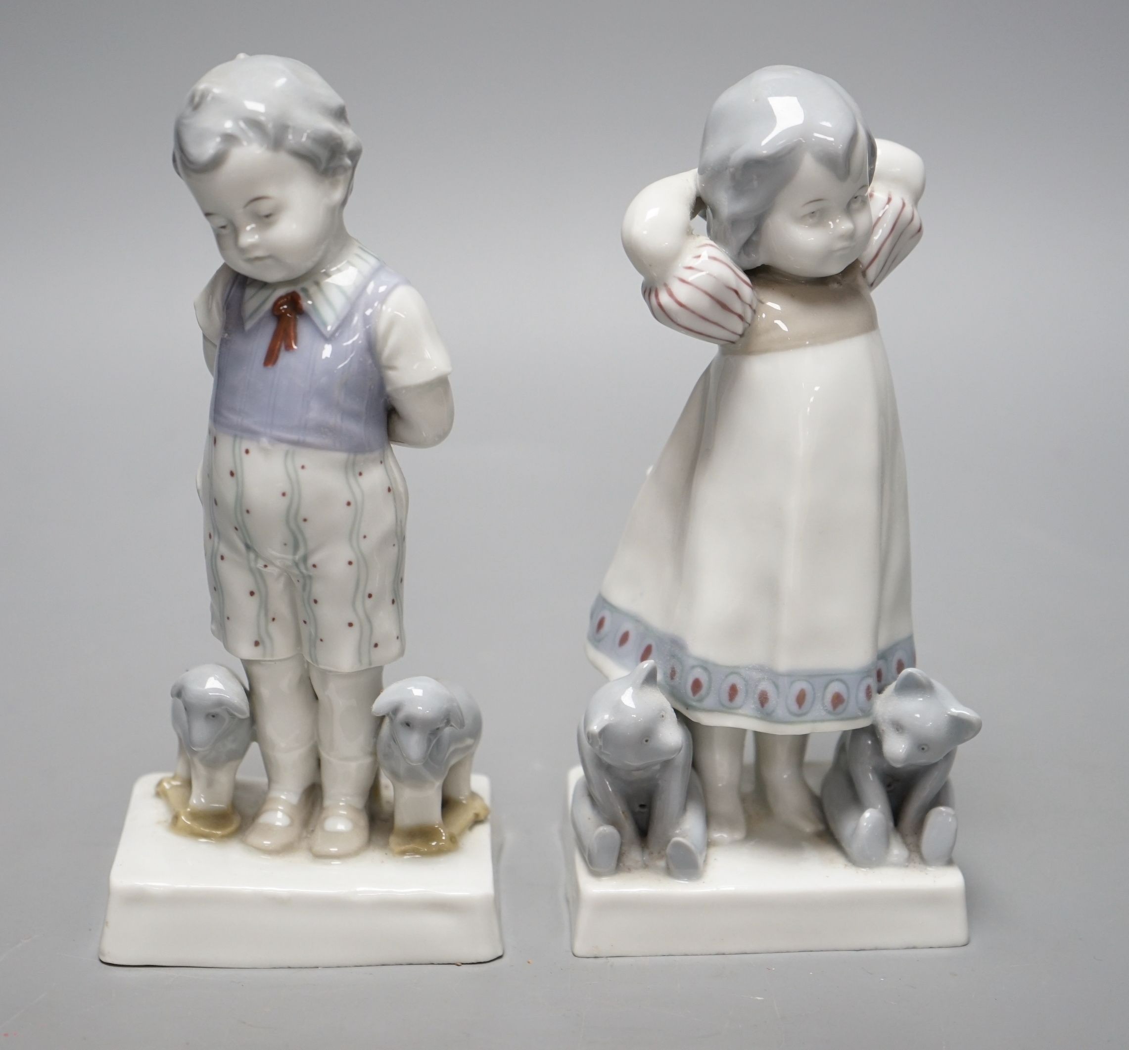 Teddy bear & Steiff collector’s interest - a pair of 1920s German Goebel porcelain figures of a girl and two teddy bears and a boy with two pull-along sheep on wheels, 17cms high
